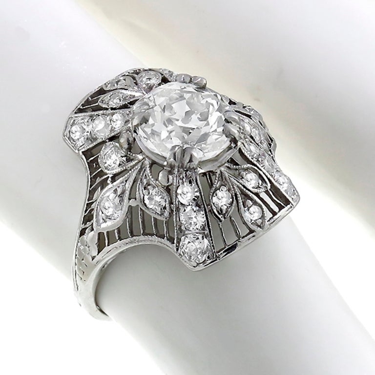 Handcrafted from the Art Deco era, this ring centers a GIA certified old European cut diamond that weighs 1.50ct. and is graded J color with VVS2 clarity. The center stone is accentuated by old mine and French cut diamonds weighing approximately