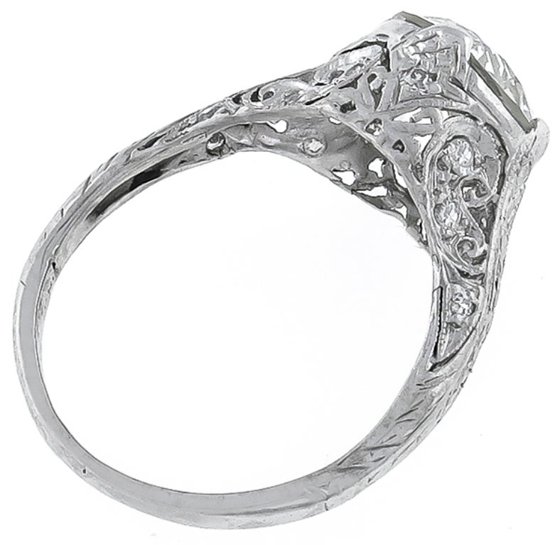 This platinum ring centers an EGL certified old European cut diamond that weighs 2.06 carat and is graded I-J color with VS1 clarity.The mounting has impressive engravings and is enhanced with dazzling round cut diamond accents.
The ring is size 5,