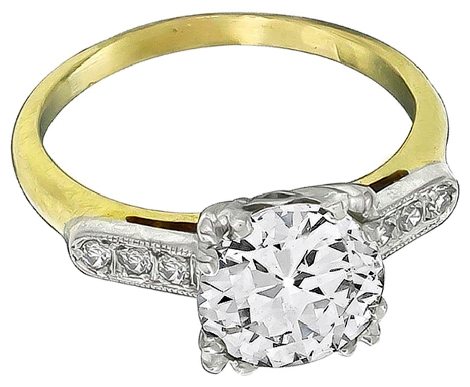 Made of 14k yellow gold and palladium, this ring centers an old mine cut diamond weighing 2.05 carat and is graded K color with VS1 clarity. The mounting is enhanced by bright round cut diamond accents.
The ring is size 6, and can be