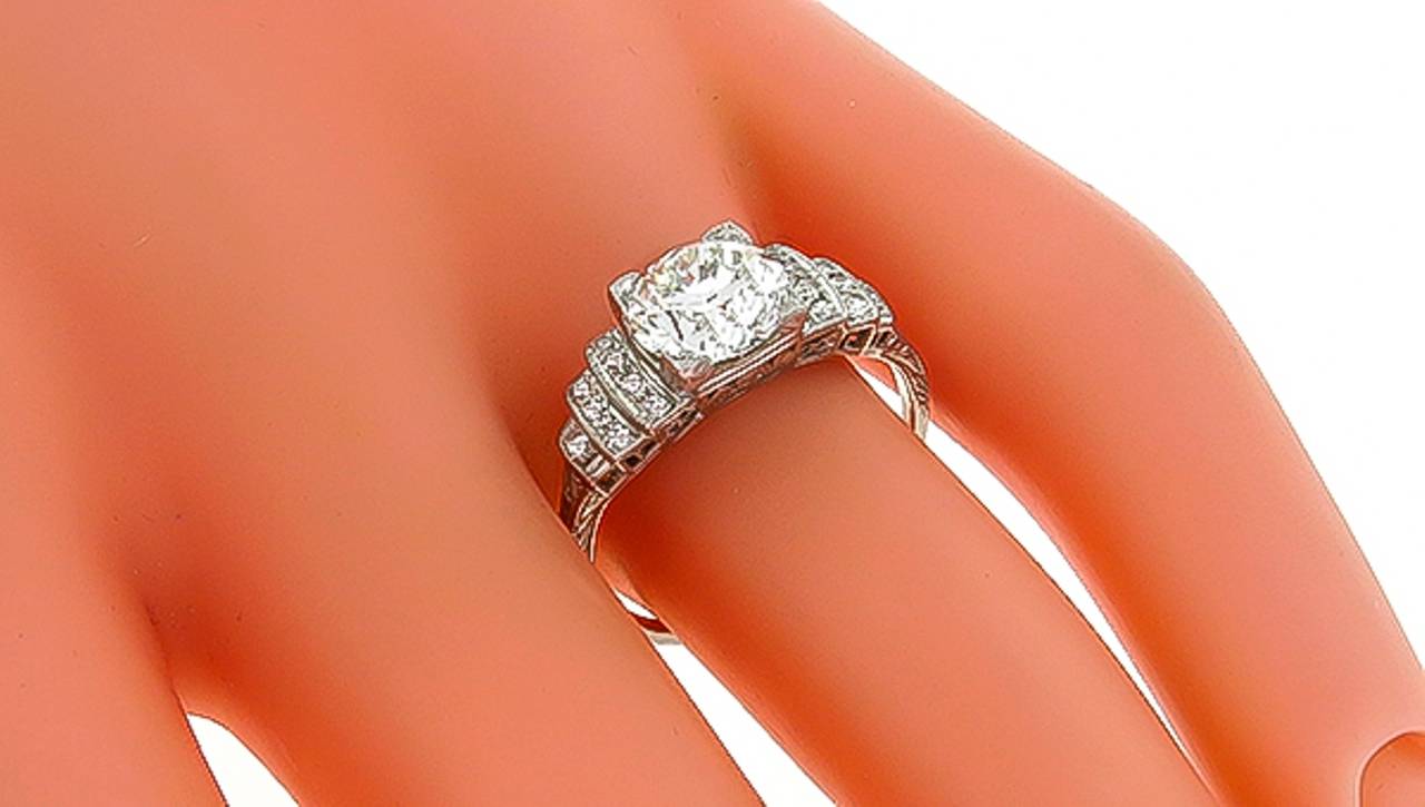 This platinum ring is centered with a GIA certified round brilliant cut diamond that weighs 1.59ct. and is graded J color with VVS2 clarity. The center stone is accentuated by round cut diamonds weighing approximately 0.20ct.
The ring is size 7,