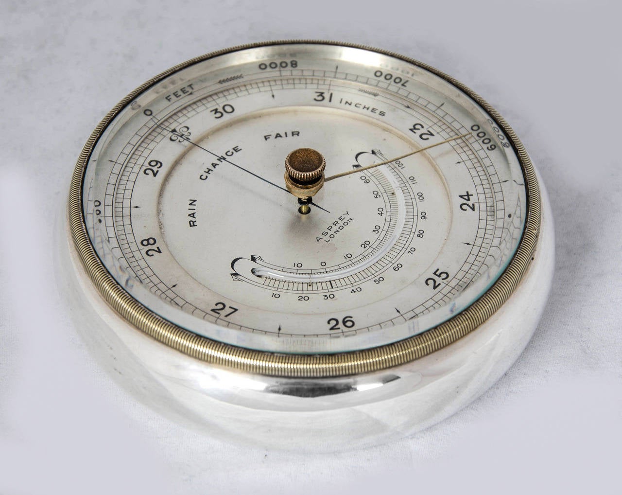An Asprey & Co.Sterling Silver Barometer, made in London, 1920.
Suitable for a desk, but has the option of being hung on the wall by a sliding ring that fits flush to the edge when not in use.
Diameter is 4