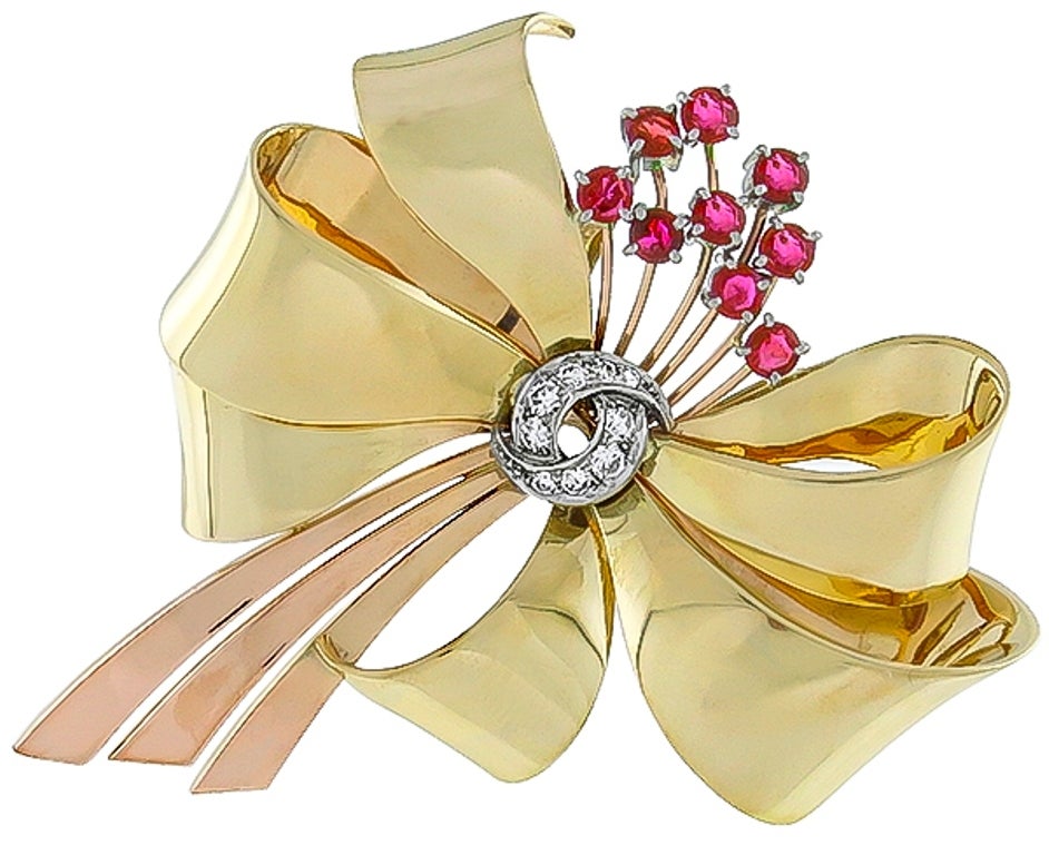 Made of 14k yellow and rose gold, this pin is set with round cut rubies weighing approximately 1.50ct. and round cut diamonds weighing approximately 0.50ct. 

Inventory #64901PKOB