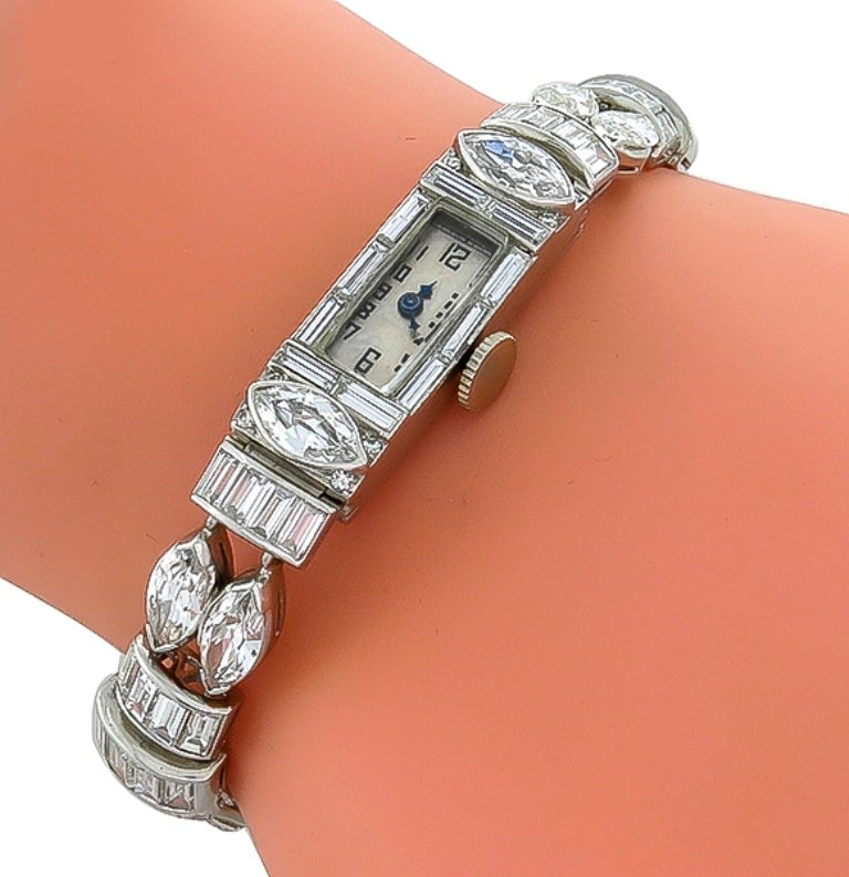 This stunning lady's platinum bracelet watch is set with marquise and baguette cut diamonds weighing approximately 17 carat. The color of the diamonds are F-G with VS1 clarity.
The watch weighs 26.9 gram and will fit a standard wrist