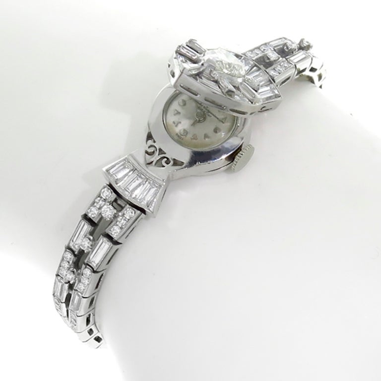 The Jules Jurgensen watch has a pear shaped diamond that weighs 1.38ct. and is graded I color with VS1 clarity. Accentuating the center diamond are round and baguette cut diamonds weighing approximately 6.25ct.
The dial is signed Est 1740.
