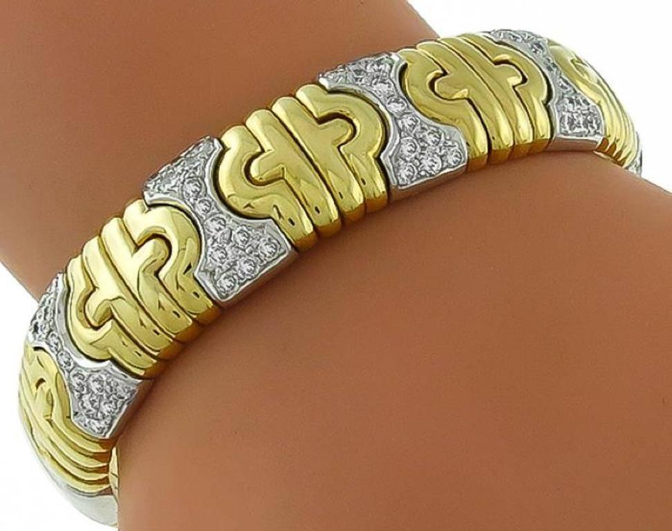 Made of 18k white and yellow gold, this bangle is set with sparkling round cut diamonds that weigh approximately 2.50ct. The color of the diamonds is G with VS clarity. The bangle measures 13mm in width and will fit a standard wrist size.
