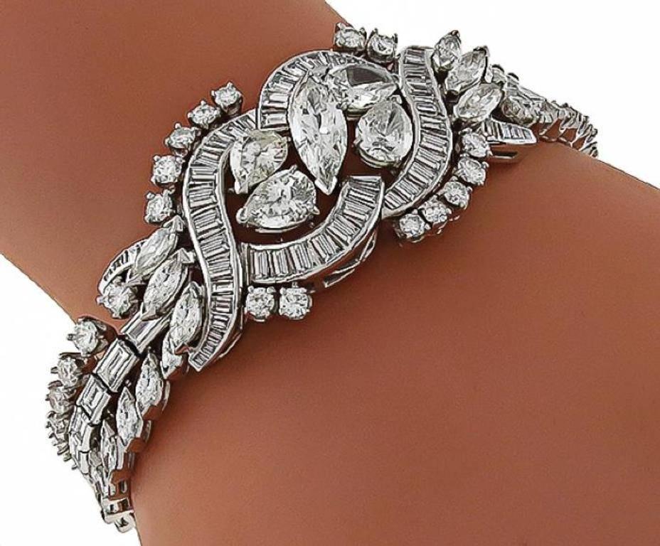 This enticing platinum bracelet from the 1950s. features sparkling round, pear, baguette and marquise cut diamonds that weigh approximately 20.00ct. The color of the diamonds is F-H with VS clarity. The bracelet measures 25mm in width at the widest