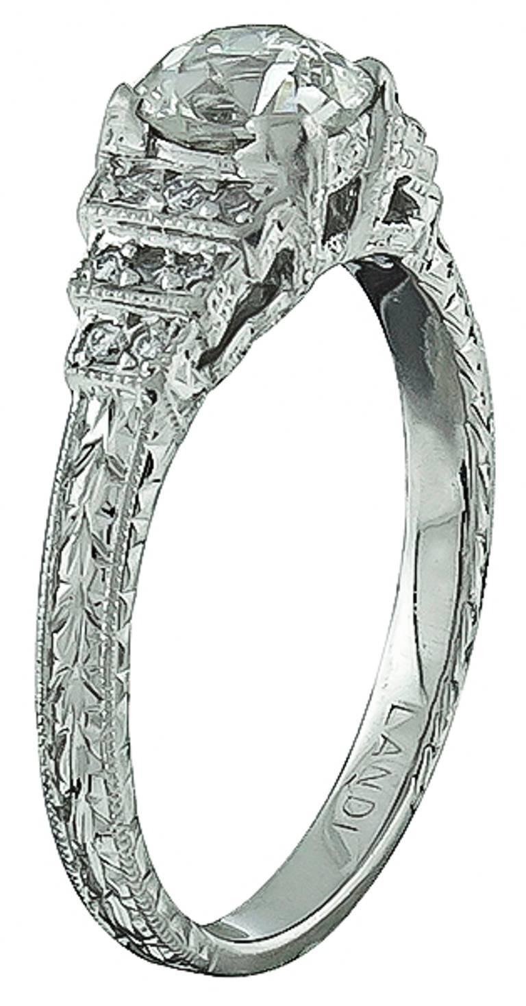 This stunning platinum ring centers a sparkling old mine cut diamond that weighs 0.77ct. graded K-L color with VS1 clarity. The center stone is accentuated by dazzling round cut diamond accents.
The ring is size 5 3/4, and can be