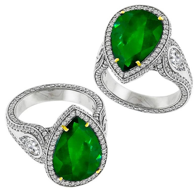 Made of 14k white gold, this ring is centered with a high quality pear shape emerald that weighs 3.72ct. The emerald is accentuated by 2 pear shape diamonds weighing approximately 0.50ct. graded I color with SI1 clarity, and small round cut diamonds