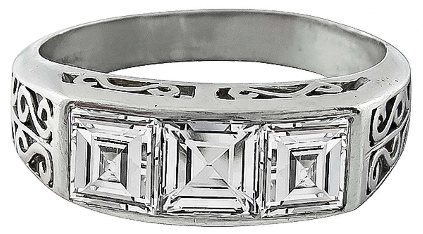This gorgeous platinum ring is set with 3 sparkling square cut diamonds that weigh approximately 2.50ct. The color of the diamonds is G with VS clarity. The ring has a tapering width from 3mm to 7mm. 
The ring is size 8 1/2, and can be