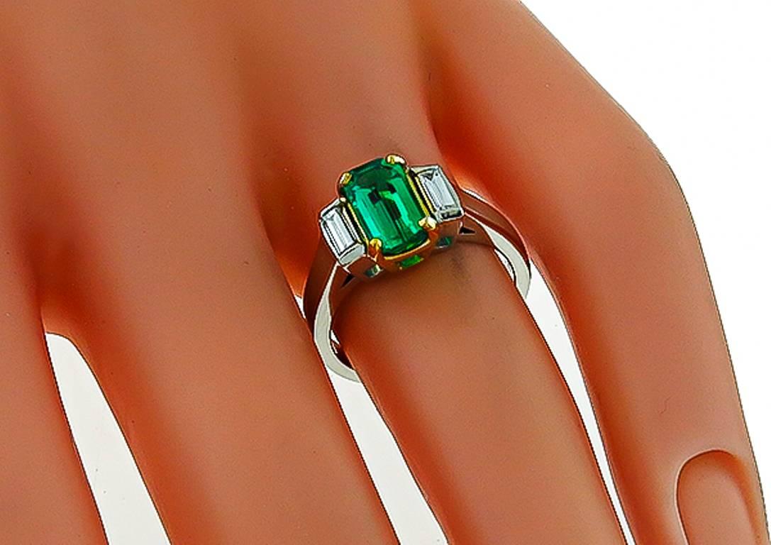 This amazing platinum ring is centered with a lovely emerald cut Colombian emerald that weighs 1.08ct. The center stone is flanked by sparkling baguette cut diamonds weighing approximately 0.25ct. graded H color with VS clarity. 
The ring is size 4