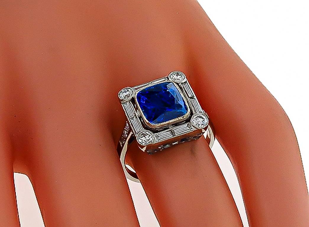 This charming 18k white gold ring is centered with a natural cushion cut Ceylon cornflower blue sapphire that weighs 3.62ct. The sapphire is accentuated by sparkling baguette and round cut diamonds that weigh approximately 0.92ct. graded H color