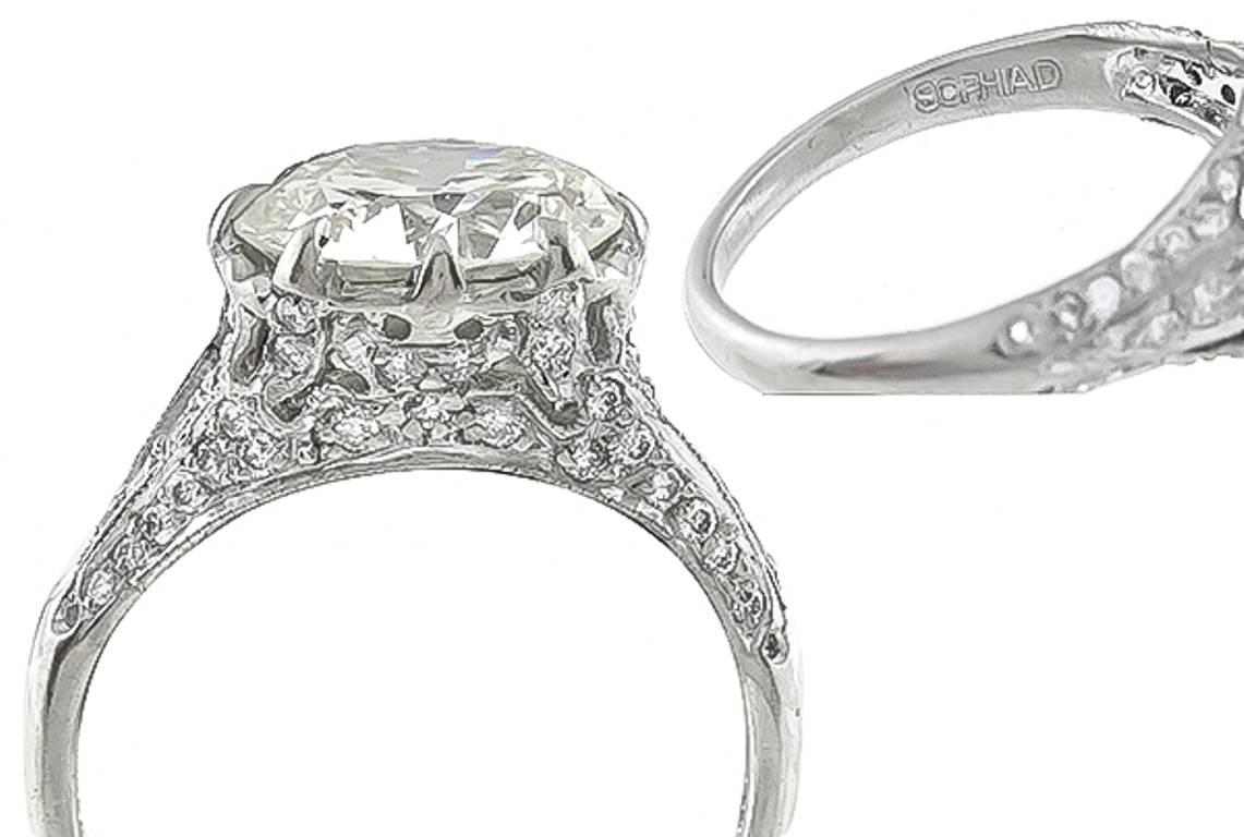 This stunning platinum ring centers a sparkling EGL certified transitional round brilliant cut diamond that weighs 3.10ct. and is graded K color with VS1 clarity. Accentuating the center stone are dazzling round cut diamonds weighing approximately