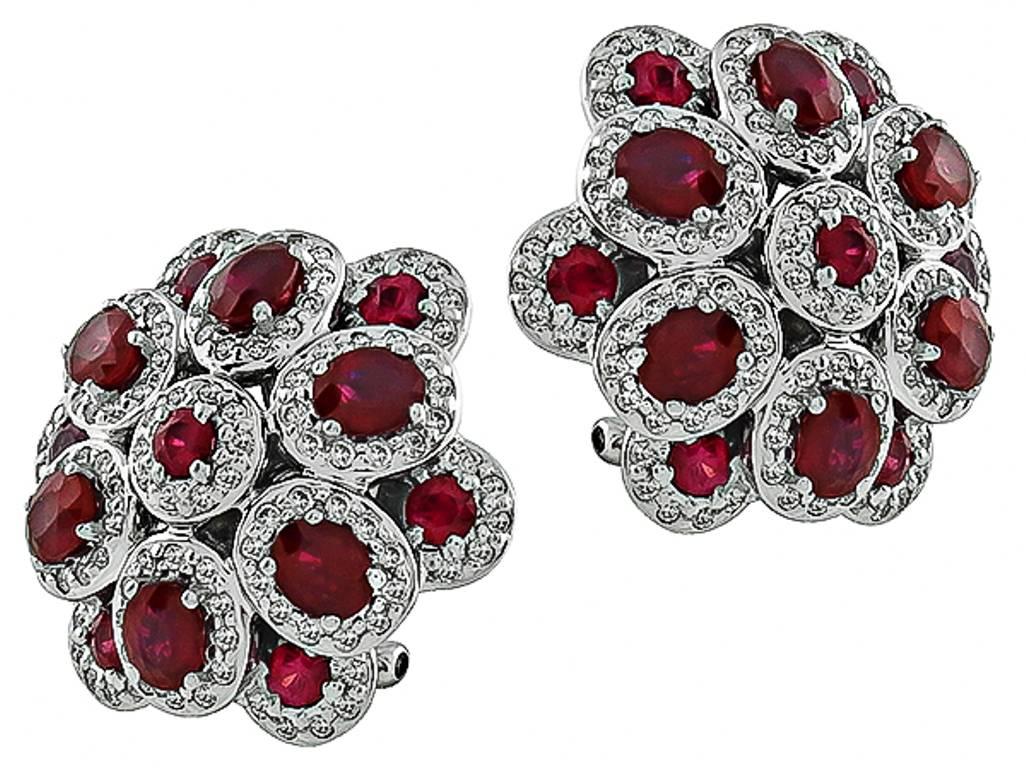 This stunning pair of 18k gold earrings feature oval and round cut rubies that weigh 2.80ct. The rubies are accentuated by sparkling round cut diamonds that weigh 0.62ct. graded I color with VS1 clarity. The earrings are stamped K18 750 and the