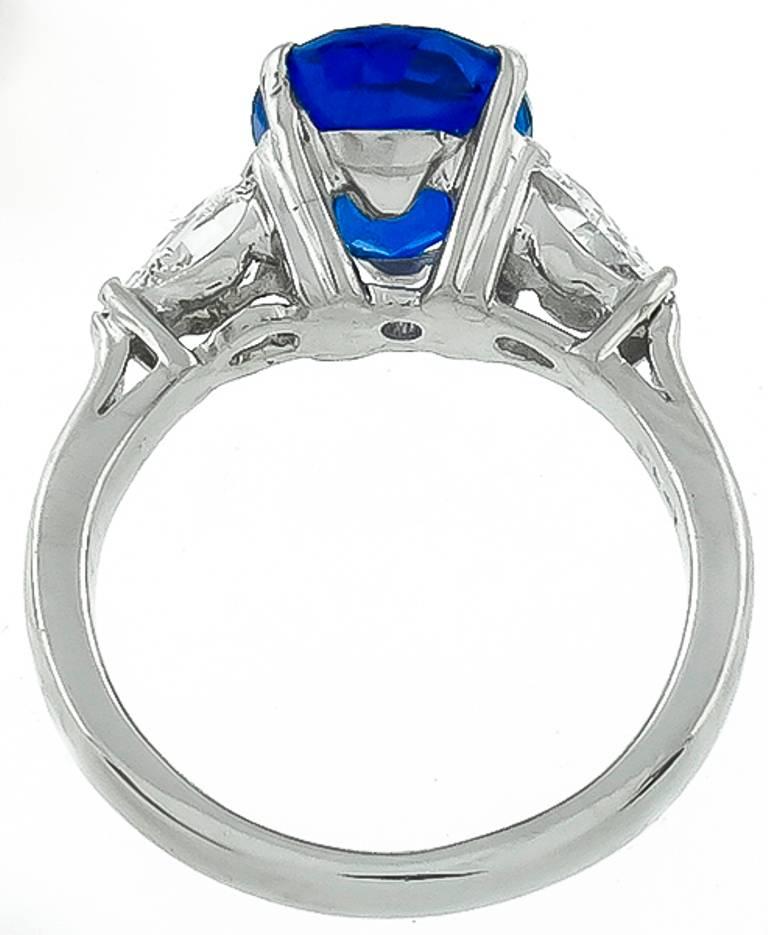 This stunning platinum ring centers a vivid blue oval cut sapphire that weighs 3.99ct. The sapphire is flanked by two sparkling pear shape diamonds that weigh approximately 0.70ct. and are graded F color with VS1 clarity.
The ring is currently size