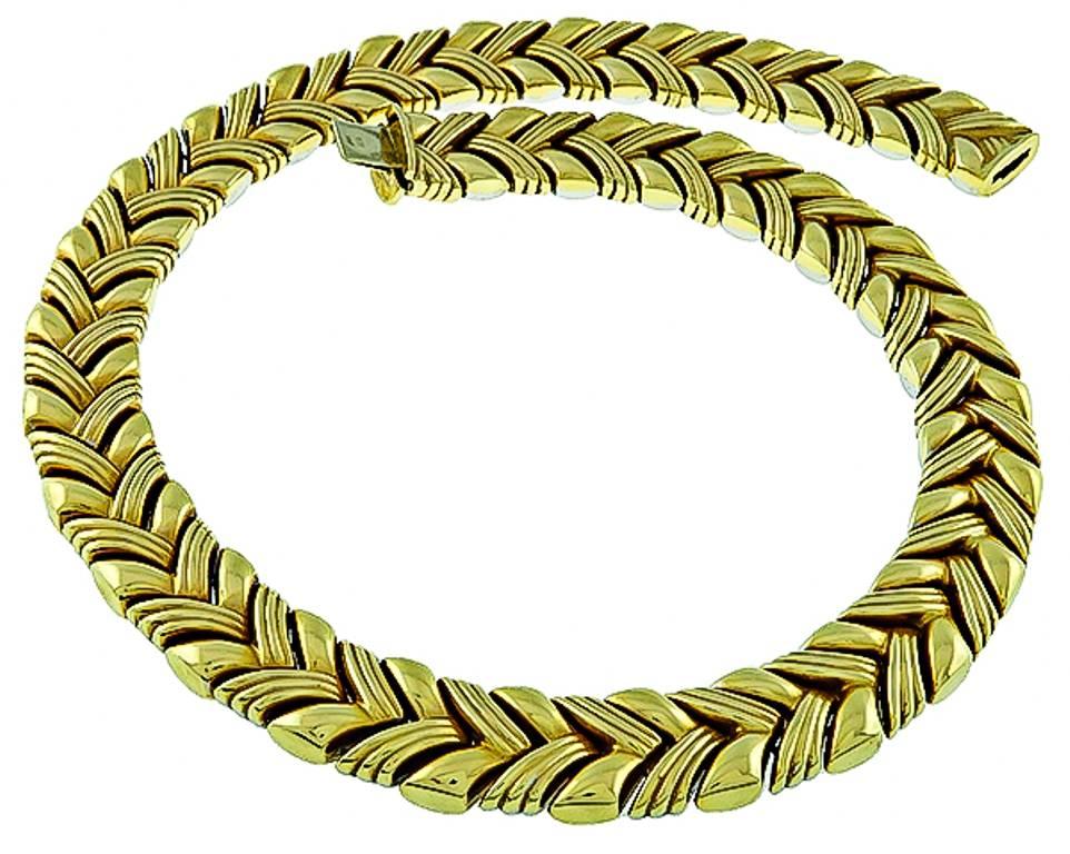 This amazing two tone 14k yellow and white gold reversible necklace measures 14mm in width and 16 1/2 inches in length. It is stamped ITAL Kt14 and weighs 75.3 grams.

Inventory #16592PEWS
