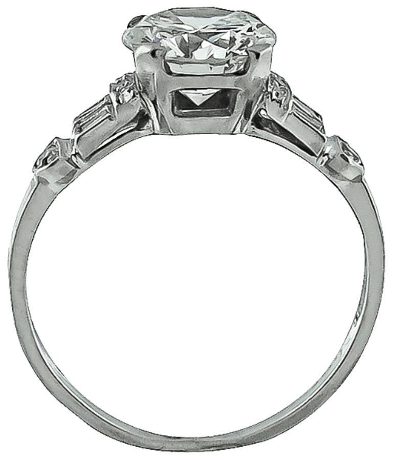 This beautiful platinum ring from the Art Deco era is centered with a sparkling GIA certified round brilliant cut diamond that weighs 1.52ct. graded K color with VVS1 clarity. The center stone is accentuated by dazzling baguette and round cut