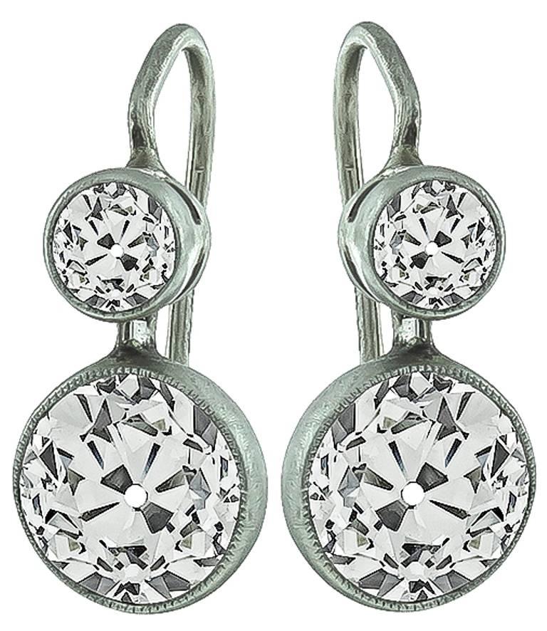 Made of 14k white gold, these earrings feature sparkling old mine cut diamonds that weigh approximately 3.50ct. and are graded J-K color with VS clarity. The diamonds are accentuated by two small old mine cut diamonds weighing approximately 0.50ct.