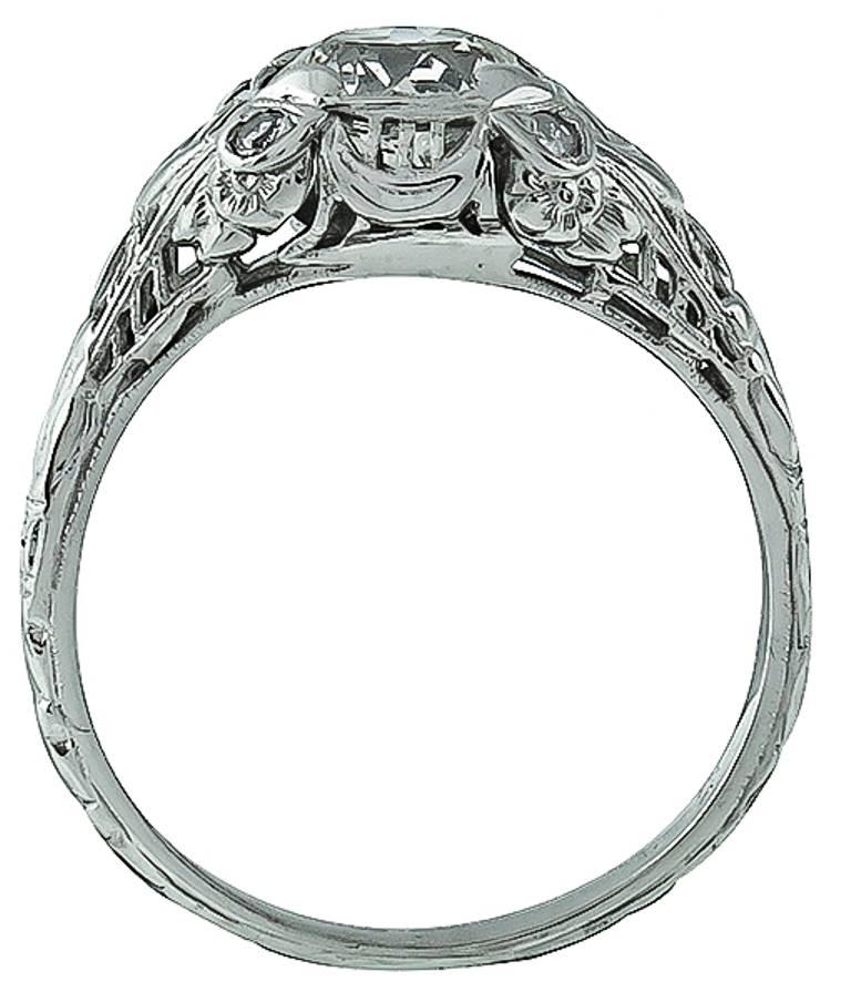 This is a charming 18k white gold engagement ring from the Edwardian era, is centered with a sparkling GIA certified circular brilliant cut diamond that weighs 1.27ct. and is graded I color with VS2 clarity. The center stone is accentuated by