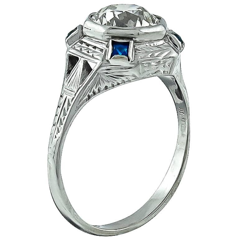 This charming 14k white gold ring from the Art Deco era, centers a sparkling old european cut diamond that weighs 1.61ct. graded K color with VS1 clarity. The center diamond is accentuated by lovely sapphire accents.
It is currently size 7, and can
