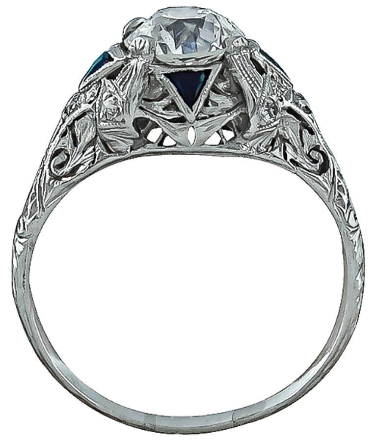 This fabulous platinum engagement ring from the Art Deco era, is centered with a sparkling GIA certified round brilliant cut diamond that weighs 1.57ct. and is graded I color with SI1 clarity. The center stone is accentuated by sparkling diamond and