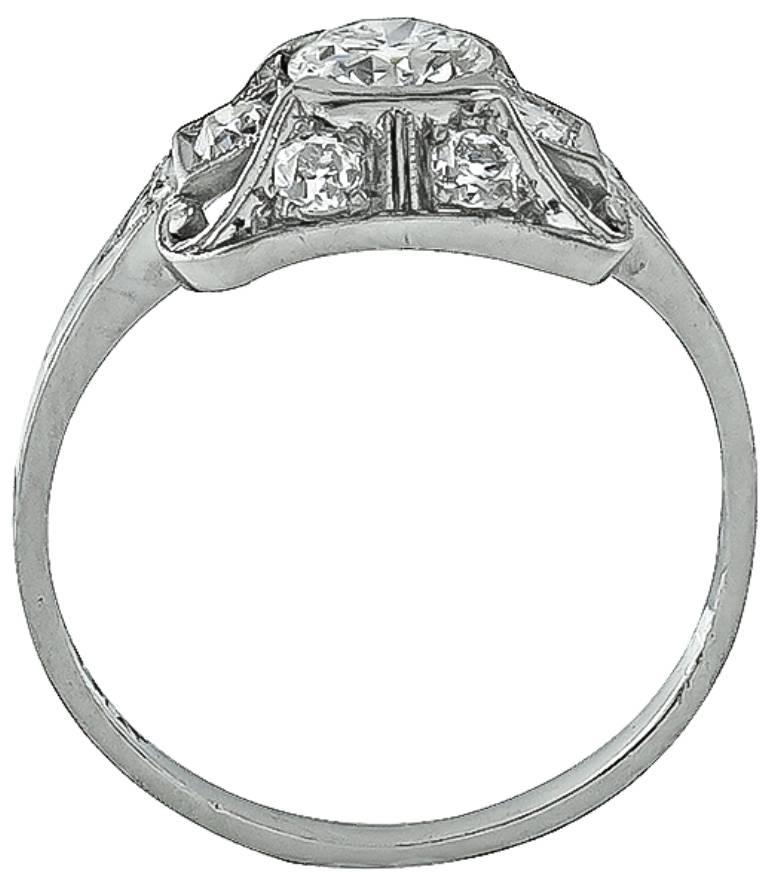 This platinum engagement ring from the Art Deco era, centers a sparkling GIA certified circular brilliant cut diamond that weighs 0.51ct. graded G color with VS1 clarity. The center diamond is accentuated by dazzling old mine cut diamond accents.
