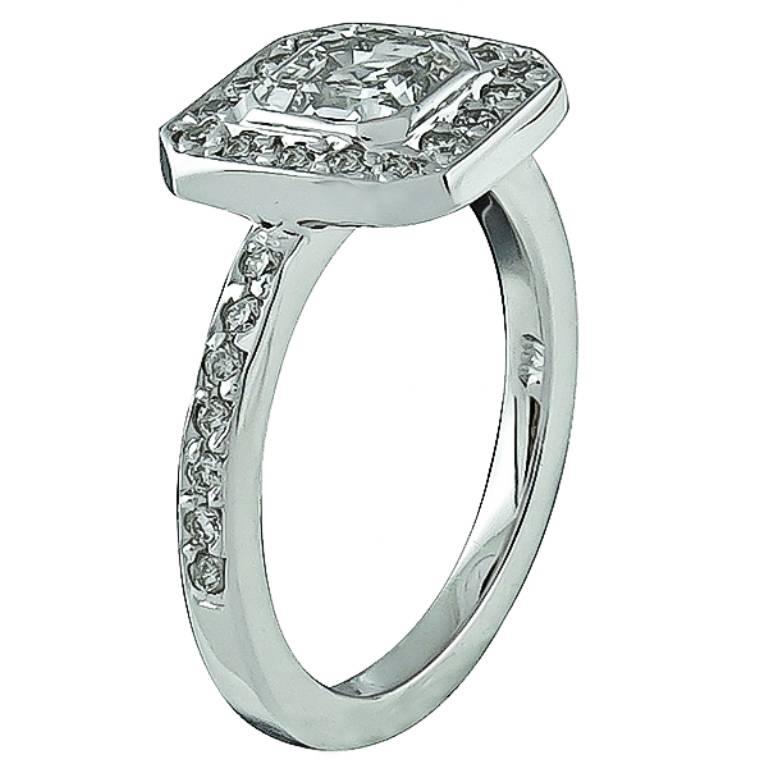 Made of 14k white gold, this ring is centered with a sparkling asscher cut diamond that weighs 1.01ct. graded G color with SI1 clarity. Accentuating the center stone are dazzling round cut diamonds weighing approximately 0.30ct. graded H color with