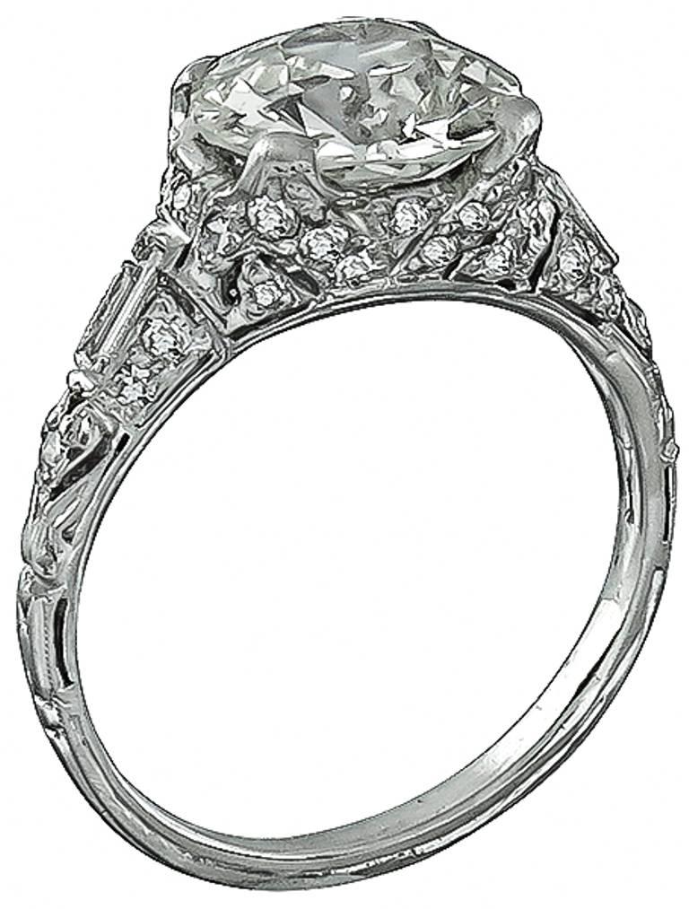 This stunning platinum ring from the Art Deco era, centers a sparkling EGL certified old European cut diamond that weighs 2.02ct. and is graded J-K color with VS2 clarity. Accentuating the center stone are sparkling baguette and round cut diamond
