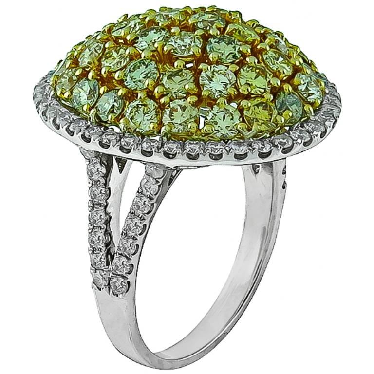 Made of 14k white & yellow gold, this ring features natural fancy colored diamonds that weigh approximately 2.80ct. The clarity of the diamond is VS1. Accentuating the colored diamonds are sparkling round cut diamonds that weigh approximately