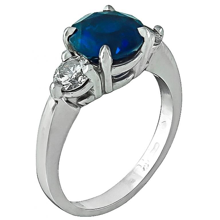 Made of platinum, this ring centers a round cut natural vivid blue sapphire that weighs 2.66ct. Accentuating the sapphire are sparkling round cut diamonds that weigh approximately 0.70ct. graded F color with VS1 clarity. The ring is stamped PLAT and