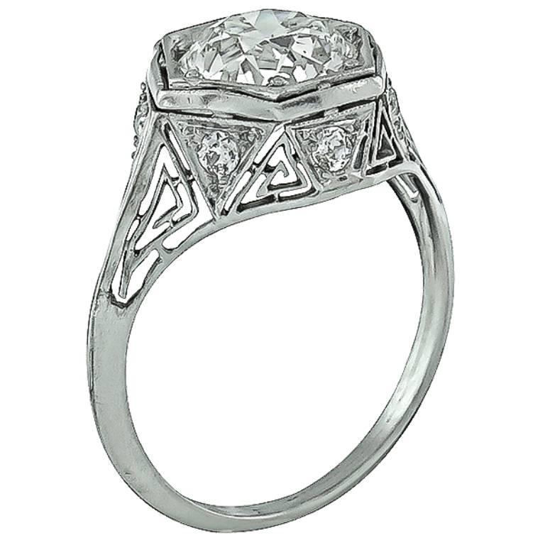 This gorgeous platinum ring from the early 20th century, is centered with a sparkling GIA certified old European brilliant cut diamond that weighs 1.98ct. graded K color with SI2 clarity. The center stone is accentuated by dazzling old mine cut