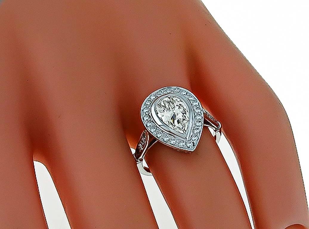 This stunning platinum engagement ring is centered with a sparkling GIA certified pear shape diamond that weighs 1.08ct. and is graded I color with VS2 clarity. Accentuating the center stone are high quality round cut diamonds weighing approximately