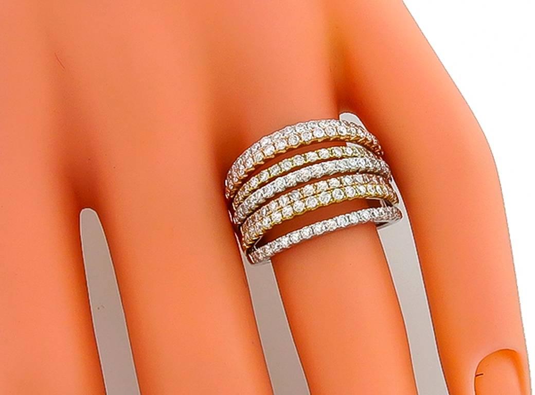 Made of 18k yellow, pink and white gold, this ring is set with sparkling round cut diamonds that weigh 1.61ct. graded G color with VS clarity. The ring has a tapering width from 5mm to 15mm. It is size 6 1/2, and can be resized.

Inventory