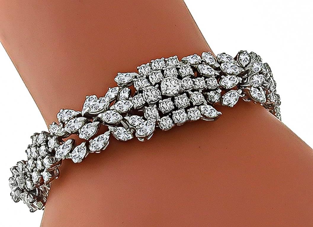 This awesome 14k white gold bracelet is set with sparkling marquise and round cut diamonds that weigh approximately 16.00ct. graded H color  with VS1 clarity. The bracelet measures 17mm in width and 7 1/4 inches in length. It weighs 48.8