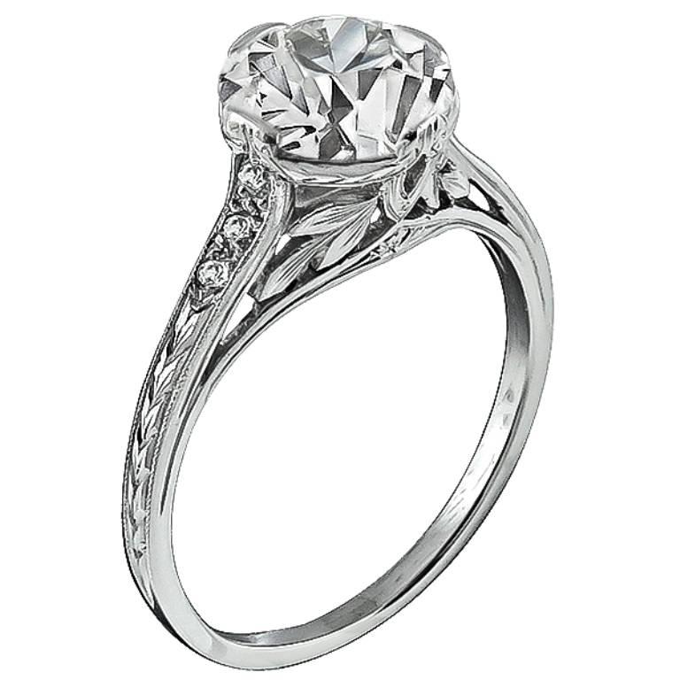 This stunning platinum ring handcrafted from the Edwardian era, centers a sparkling GIA certified circular brilliant cut diamond that weighs 2.05ct. graded G color with VS1 clarity. The top of the ring measures 8mm in diameter.
It is currently size
