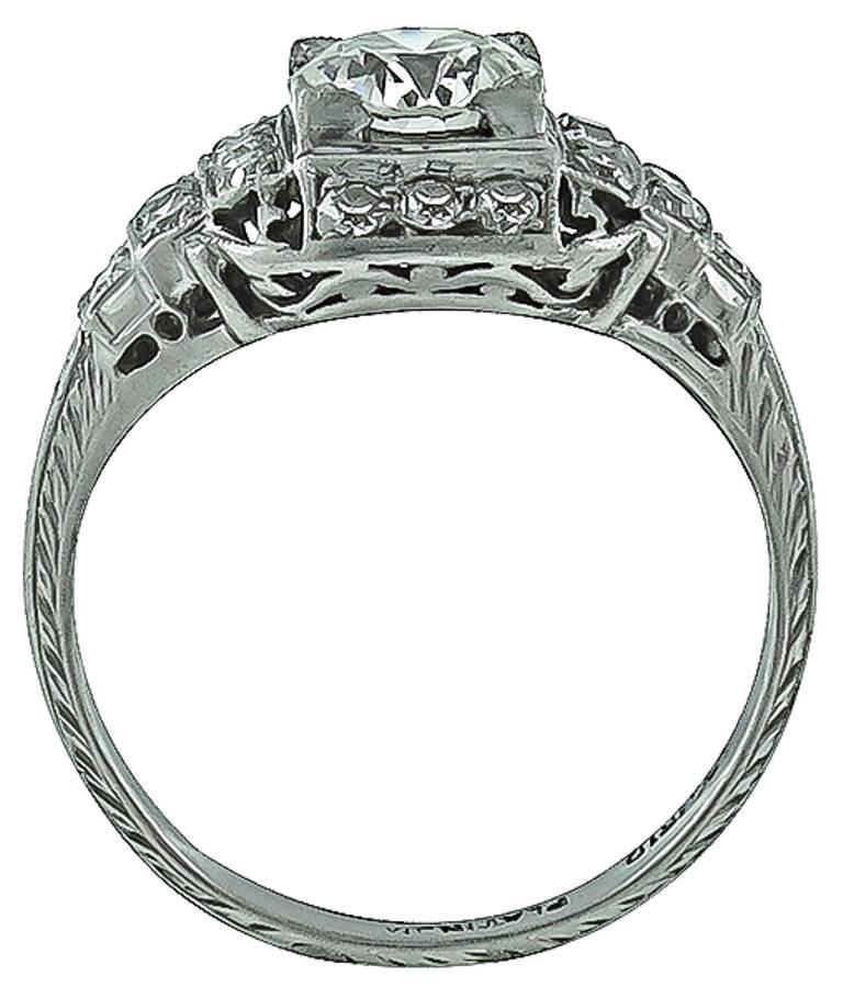 This elegant platinum engagement ring is centered with a sparkling GIA certified old European cut diamond that weighs 0.77ct. and is graded K color with VS2 clarity. Accentuating the center stone are dazzling round cut diamond accents. The top of