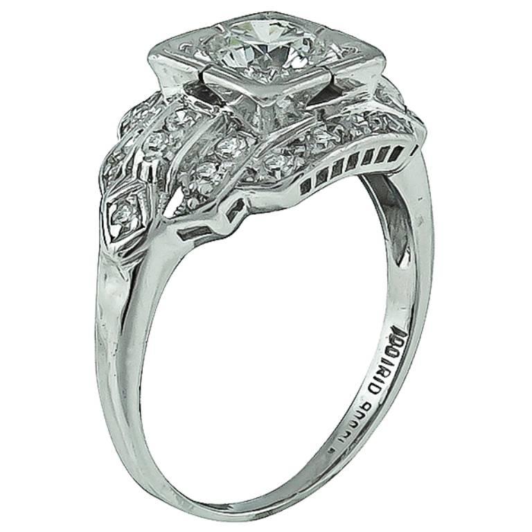 Made of platinum, this ring centers a sparkling round cut diamond that weighs approximately 0.60ct. Accentuating the center stone ar high quality sparkling round cut diamonds weighing approximately 0.50ct. The diamonds are graded G color with VS
