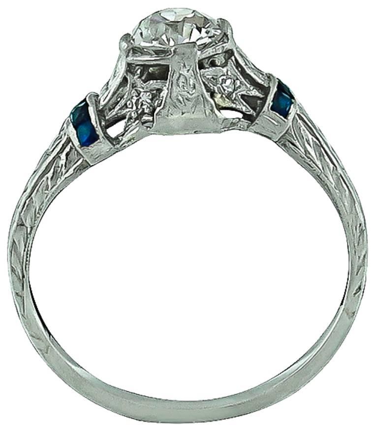 This magnificent platinum engagement ring from the Art Deco era, is centered with a sparkling GIA certified old European cut diamond that weighs 0.53ct. graded I color with VS2 clarity. The center stone is accentuated by sapphire and round cut