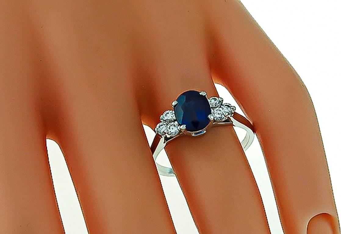 This stunning platinum ring is centered with a GIA certified oval cut Madagascar sapphire that weighs 2.13ct. Accentuating the center stone are sparkling round cut diamonds that weigh approximately 0.25ct. graded H color with VS clarity. The ring is