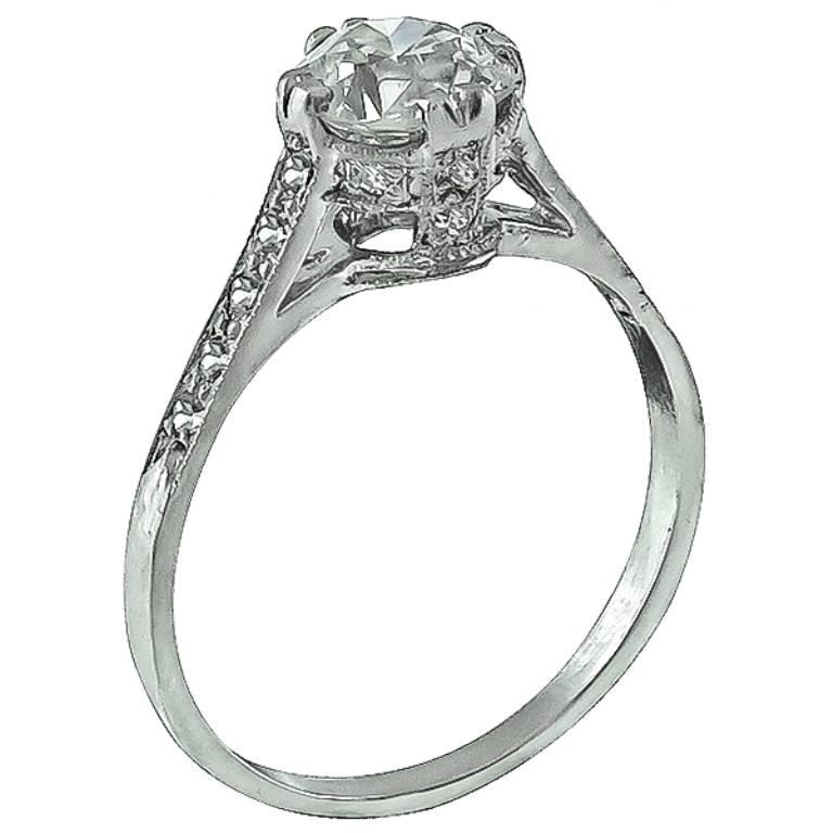 This stunning platinum engagement ring is centered with a sparkling GIA certified circular brilliant cut diamond that weighs 1.03ct. graded J color with SI1 clarity. Accentuating the center stone are high quality sparkling round cut diamond accents.