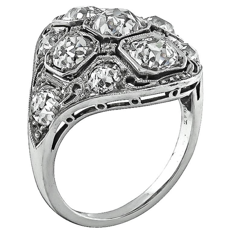 This stunning platinum ring from the Art Deco era, is set with high quality  sparkling old mine cut diamonds that weigh approximately 2.75ct. graded G color with VS1 clarity. The top of the ring measures 20mm by 19mm. It is stamped PLAT and weighs
