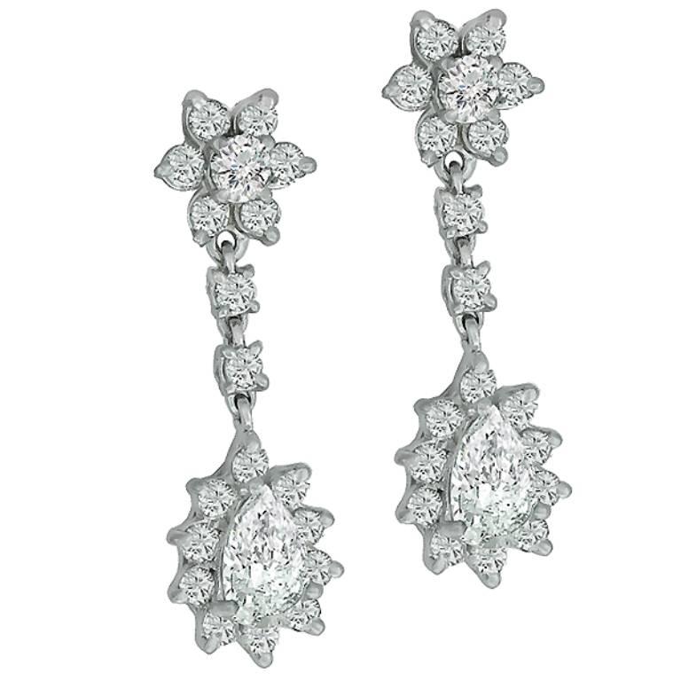 This beautiful pair of 14k white gold diamond earrings, center two stunning pear shape diamonds that weigh approximately 1.25ct. Accentuating these diamonds are high quality round cut diamonds weighing approximately 2.50ct.  The diamonds are graded