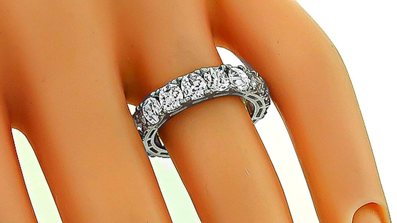 This stunning platinum eternity wedding band features sparkling old mine brilliant cut diamonds that weigh approximately 5.55ct. graded G-I color with VS1-SI1 clarity. The band measures 5mm in width and weighs 5 grams.
It is size 6