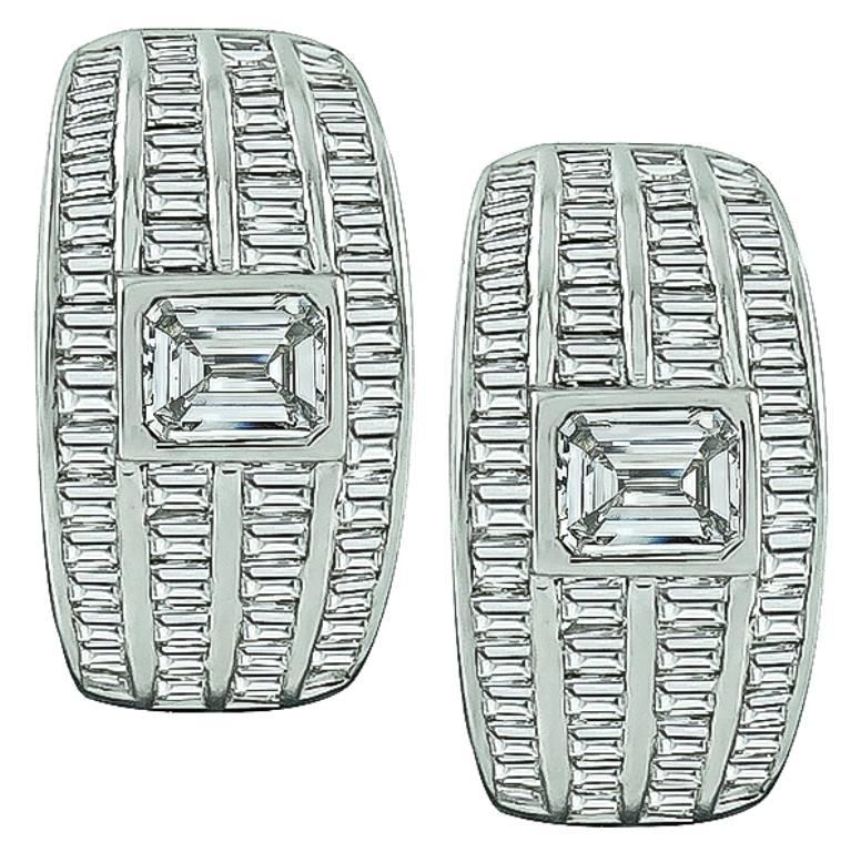 This amazing pair of 18k white gold earrings are centered with sparkling emerald cut diamonds that weigh approximately 0.90ct. Accentuating the center stones are dazzling baguette cut diamonds that weigh approximately 1.80ct. The color of the
