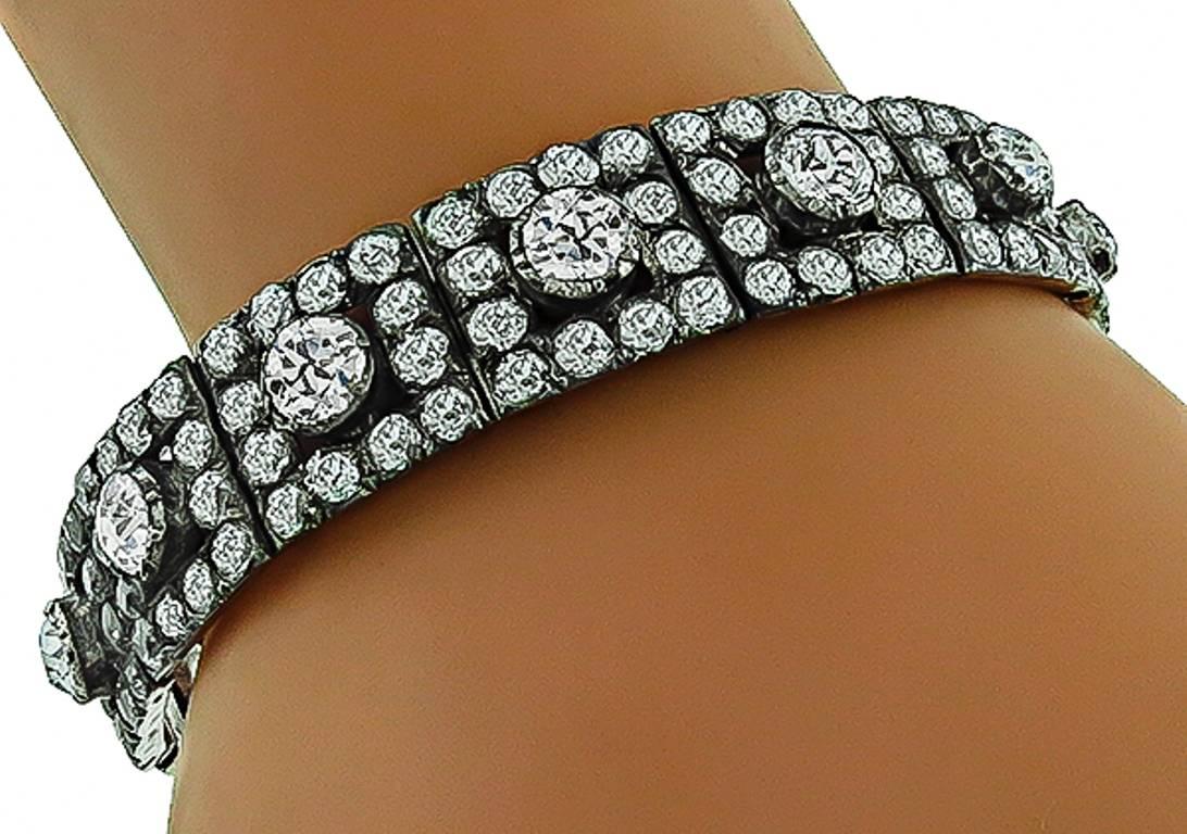 This magnificent silver bracelet from the 19th century era, is set with sparkling old mine brilliant cut diamonds that weigh approximately 31.00ct. The color of the diamonds is H-I with VS2-SI1 clarity. The bracelet has a tapering width from 10mm to