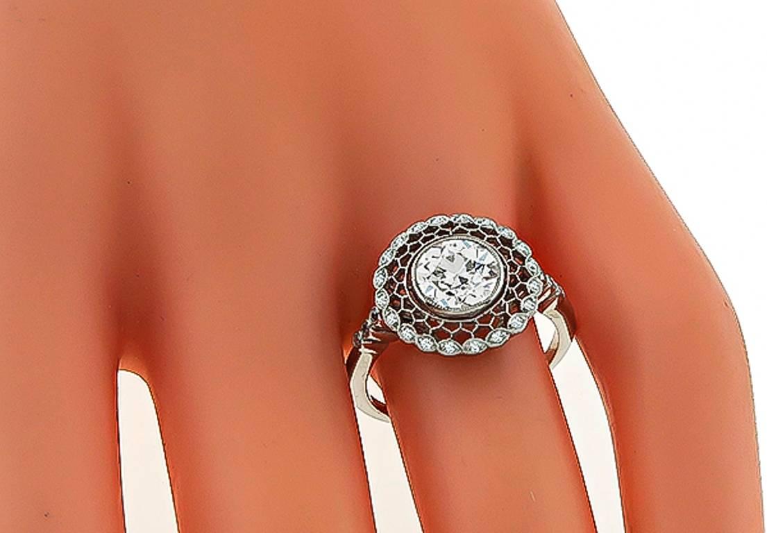 This gorgeous platinum engagement ring is centered with a sparkling GIA certified old European cut diamond that weighs 1.30ct. graded J color with VS1 clarity. Accentuating the center stone are dazzling round cut diamond accents. The top of the ring
