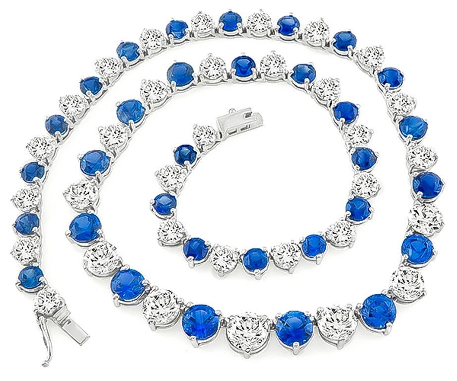 Made of 14k white gold, this necklace set with sparkling round cut diamonds that weigh approximately 22.40ct. The color of the diamonds range from G to I color, and the clarity VS1 to SI1. Accentuating the diamonds are high quality even colored blue