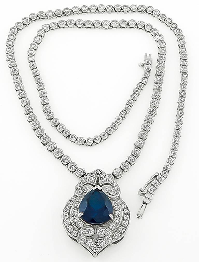 This fabulous 18k white gold necklace centers a natural pear shaped sapphire that weighs 3.50ct. The sapphire is accentuated by sparkling round cut diamonds that weigh approximately 5.00ct. graded G-H color with VS clarity. The pendant on the