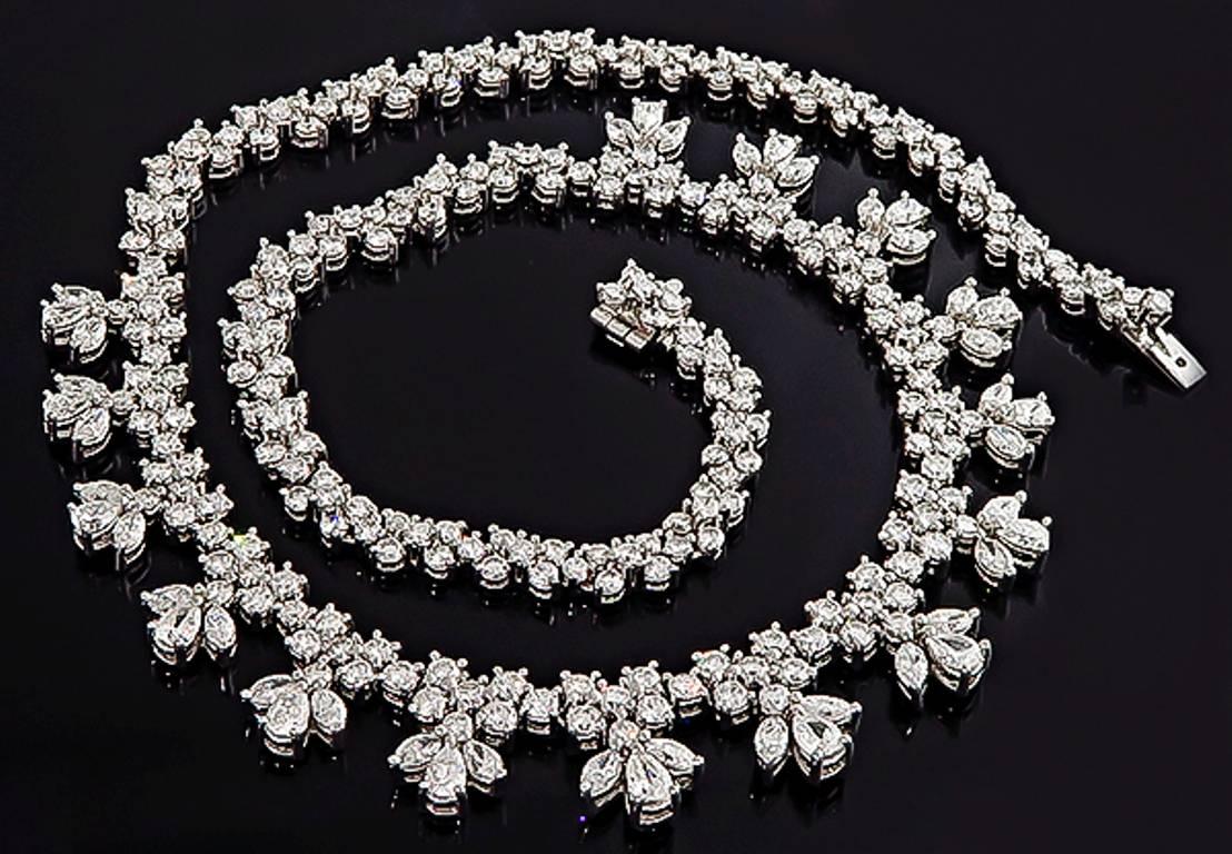 This stunning platinum necklace is set with sparkling pear, marquise and round cut diamonds that weigh 20.44ct. The color of these diamonds is F-G with VS clarity. The necklace measures 16 1/4 inches in length and weighs 68.5 grams. It is stamped