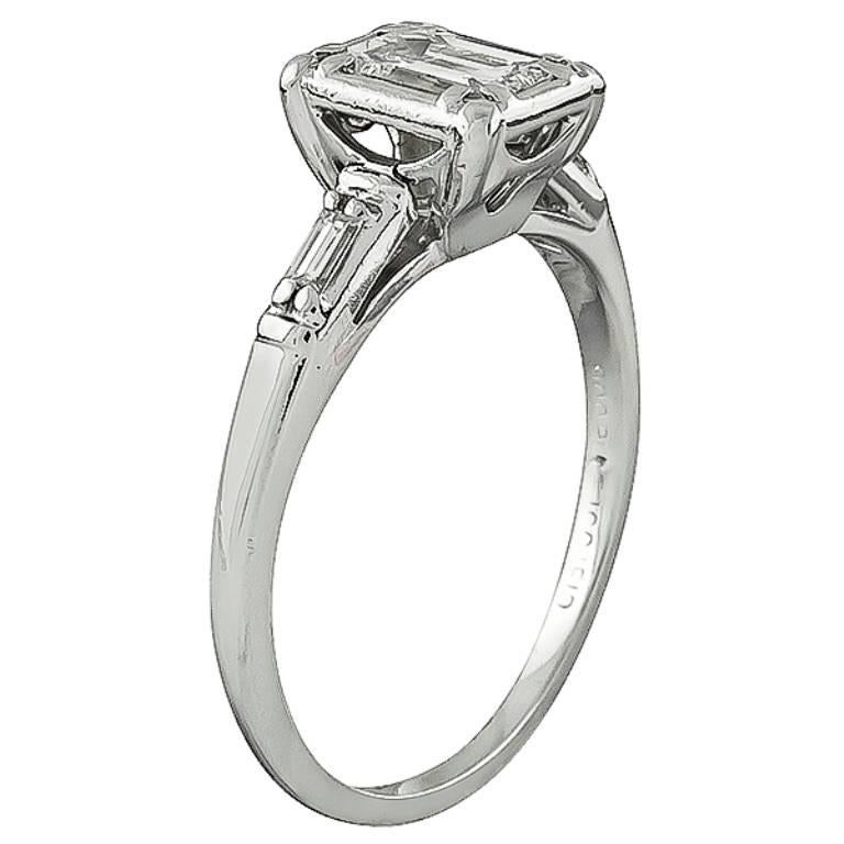 This platinum engagement ring by Jabel is centered with a sparkling emerald cut diamond that weighs approximately 0.50ct. graded G color with VS clarity. The center stone is flanked by dazzling baguette cut diamond accents. The ring is stamped JABEL