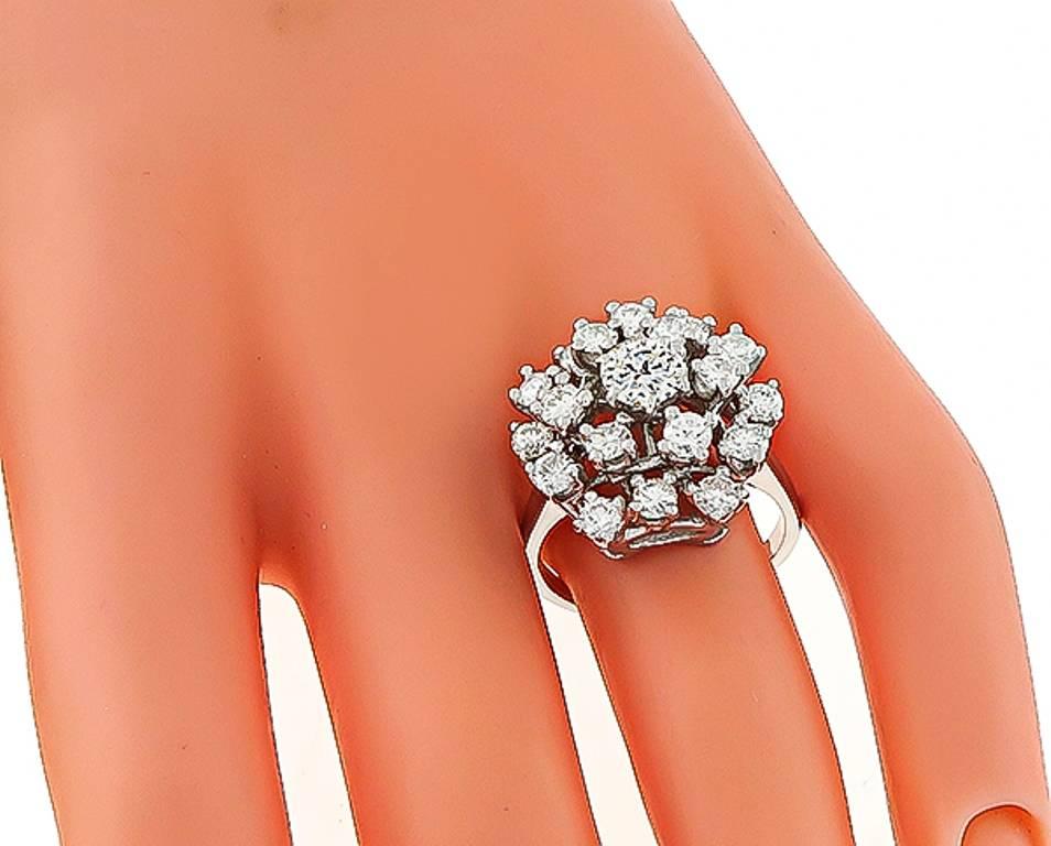 This beautiful 14k white gold ring is set with sparkling round cut diamonds that weigh approximately 2.20ct. graded G color with VS clarity. The top of the ring measures 18mm in diameter.
It is currently size 8 1/4, and can easily be